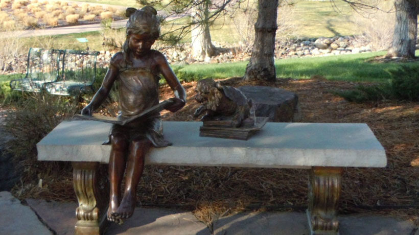 Parker Library Park girl reading book statue